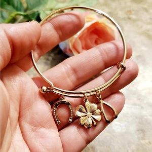 Gold plated bangle with charms.